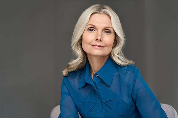 a pretty middle aged woman smiling at the camera