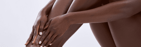 A woman's legs in a white background at a Laser Center.