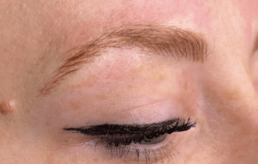 A woman's eye with a brow tattoo at a Health Spa.